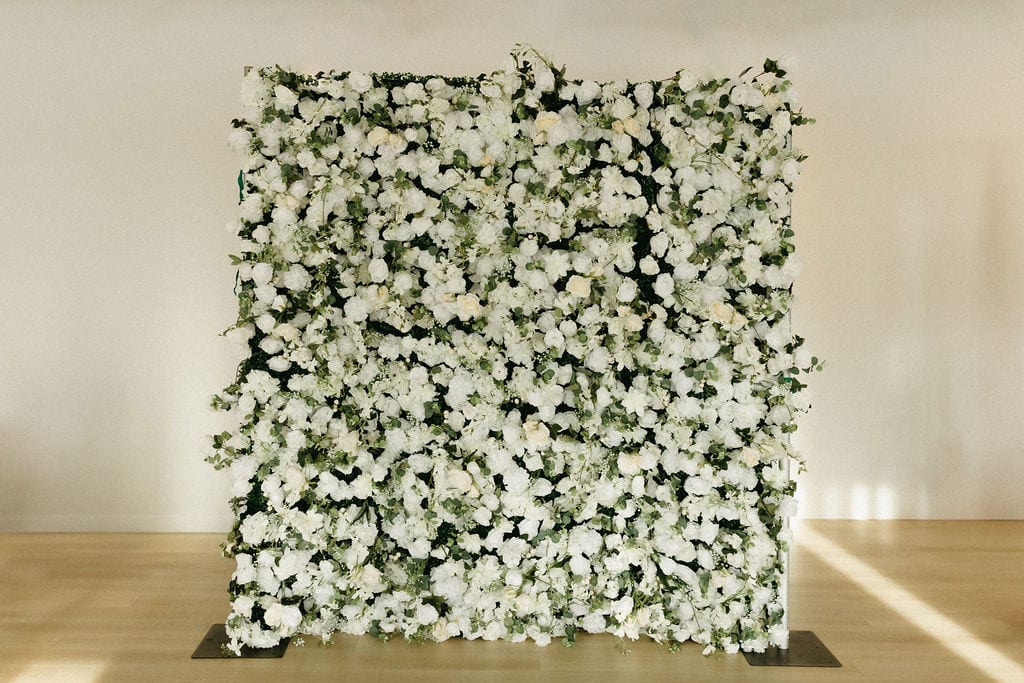 White floral backdrop for events and celebrations.